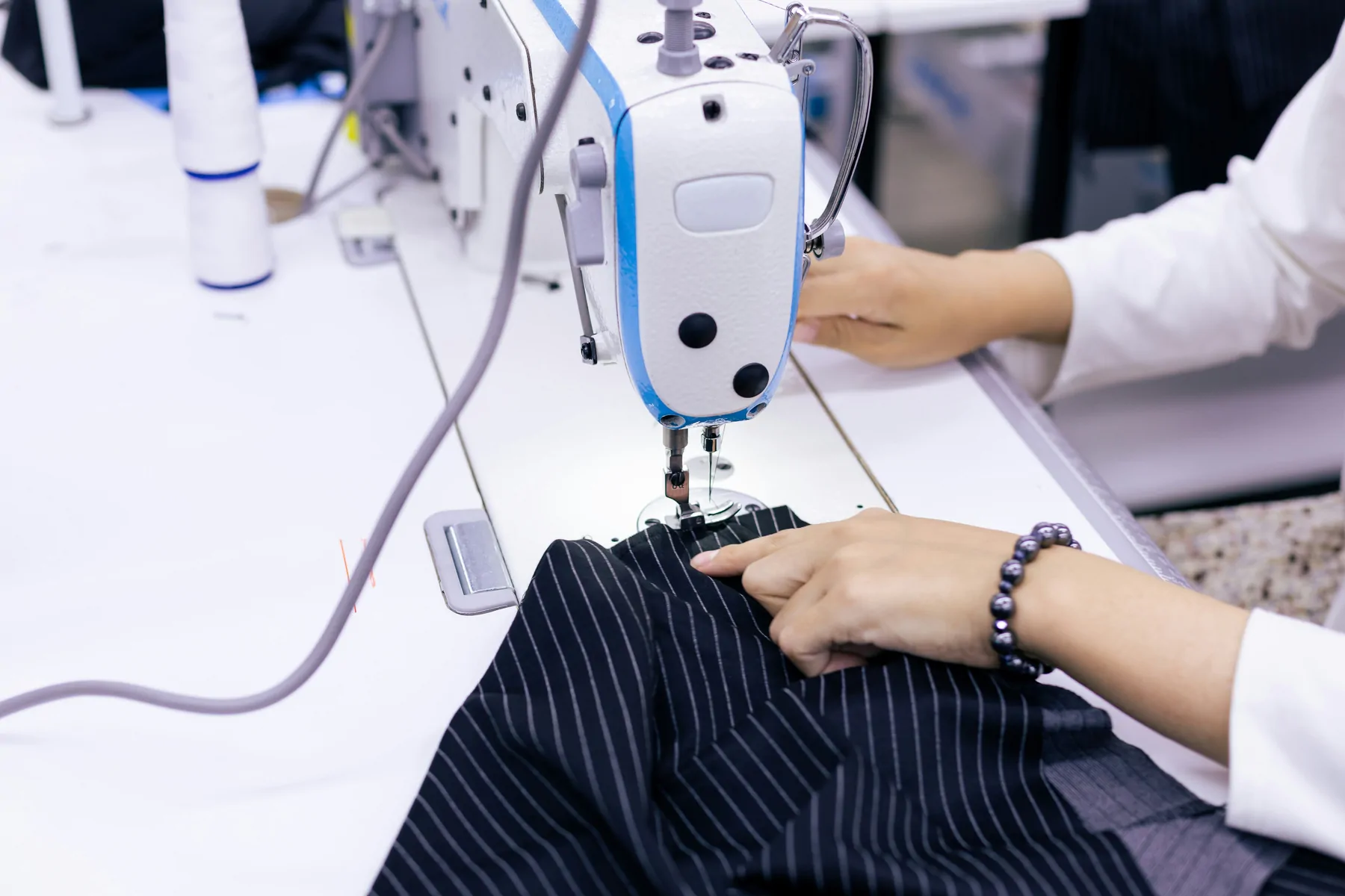 Apparel operator sewing a tailored garment for OEM and ODM production