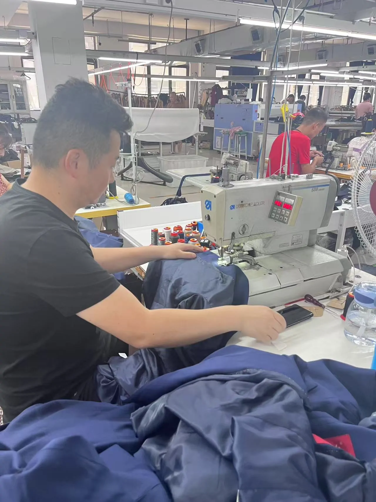 Garment sewing operator producing a bulk apparel order