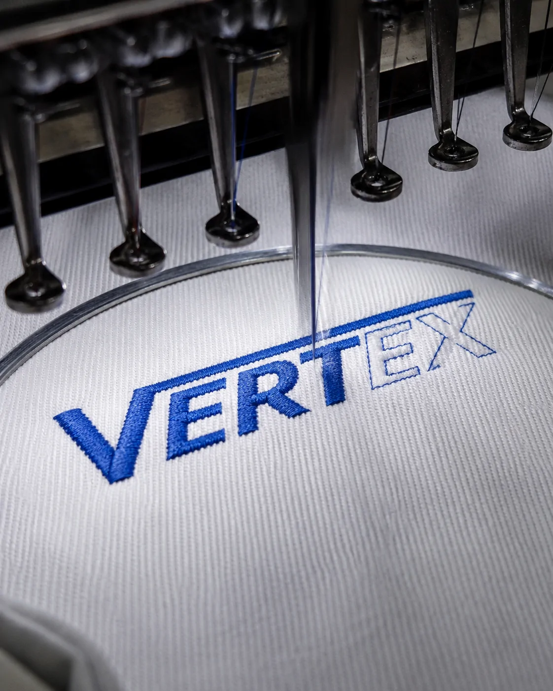 Industrial embroidery machine applying a custom logo